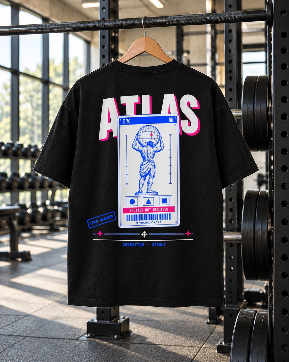 Atlas tee on a hanger on a squat rack in a sunlit gym, back print