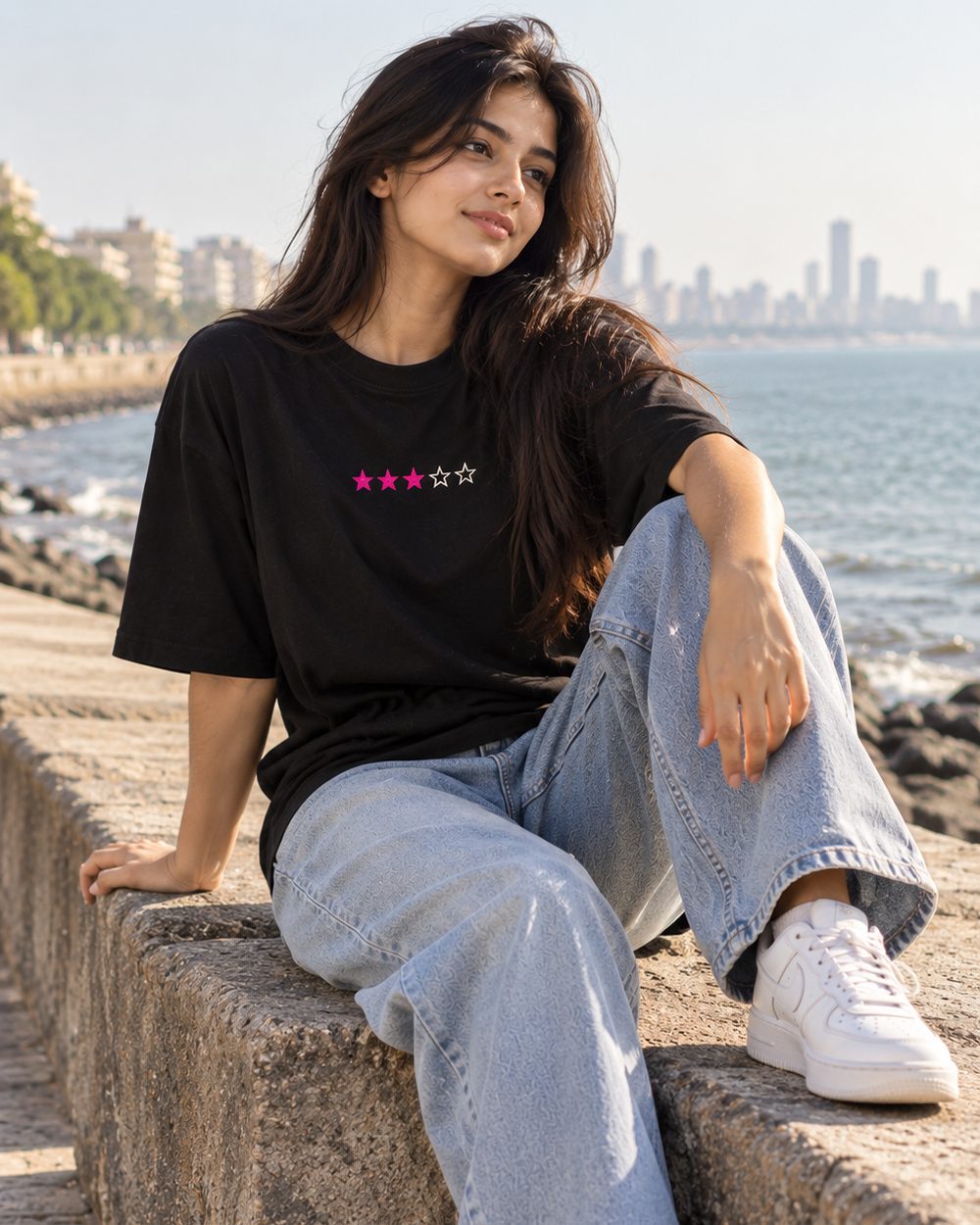 Neo Bombay tee, three-star chest print, seated on the sea wall